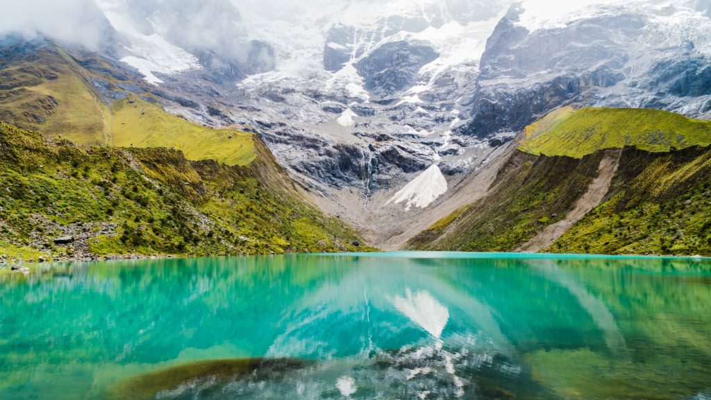 Turquoise crystal blue glacier lake in Peru