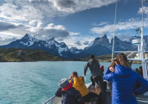 A photograph of hikers taking a ferry across Lago Pehoé to hike the W Trek in Torres del Paine National Park