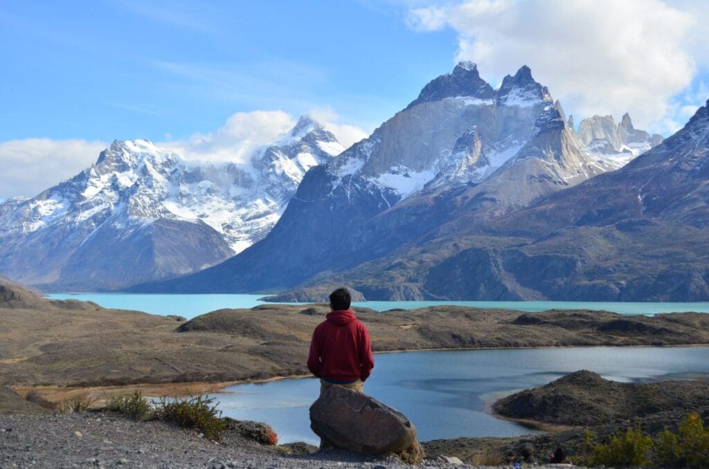 Man sitting on rock by Mirador Nordenskjöld on Torres del Paine W Trek