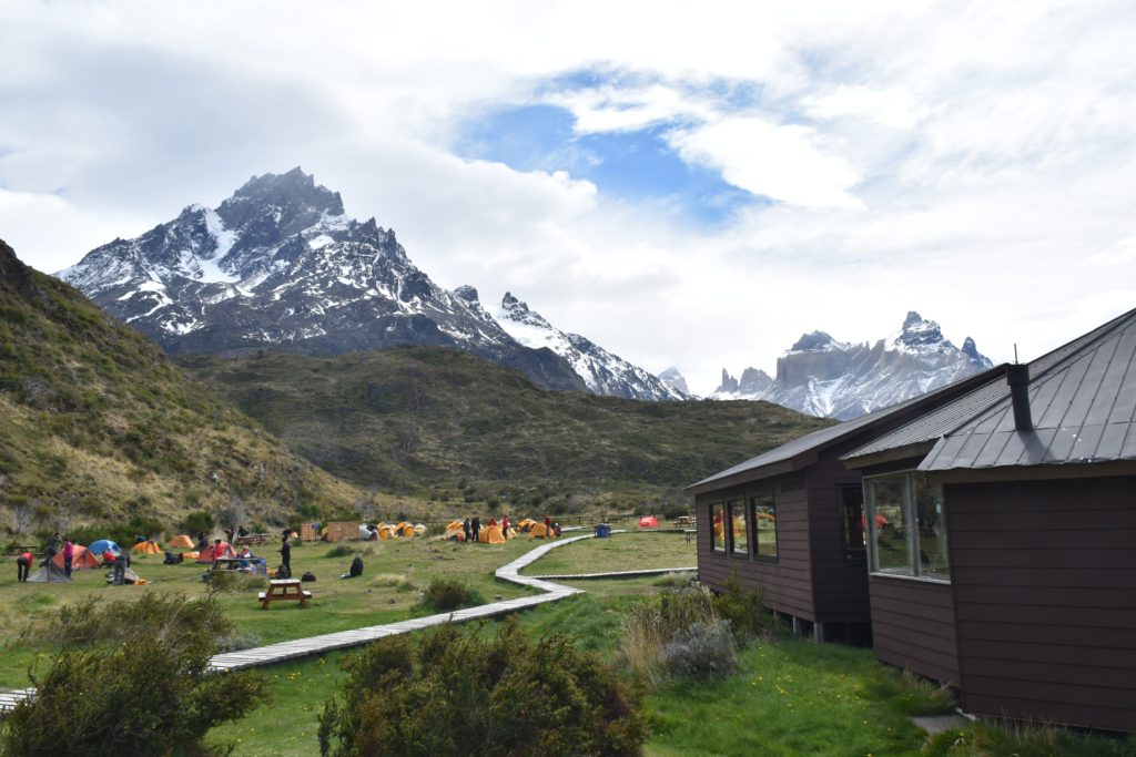 Mountain hut and tents surrounded by Patagonian mountains