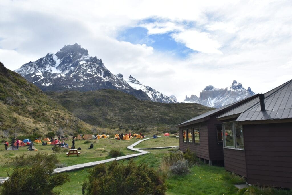 Mountain hut and tents amid Patagonian peaks on Torres del Paine W Trek