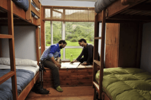 An interior photograph of a six-person room with bunk beds in a mountain hut in Torres del Paine National Park. These lodges are common for those hiking the W Trek to stay in