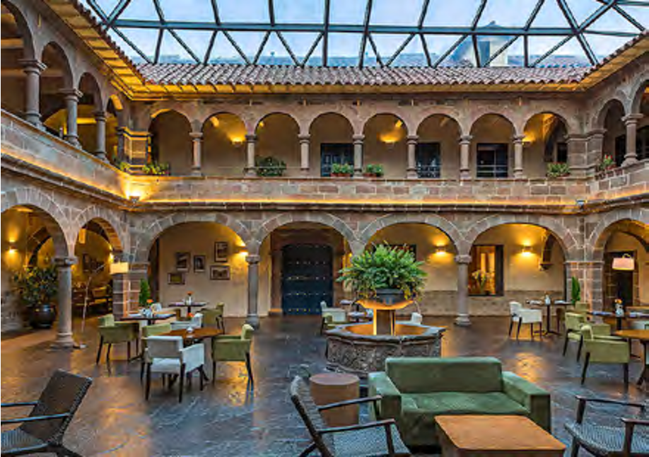 A photograph of the interior courtyard of Novotel Hotel in Cusco, Peru, highlighting the beautiful colonial architecture. This hotel is an excellent starting point for Inca Trail tours in the Sacred Valley