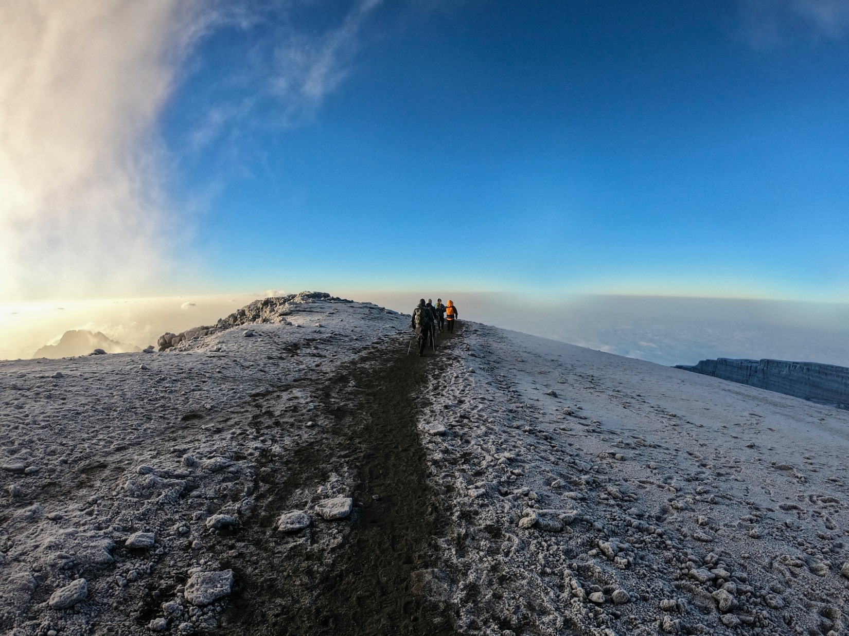 Group of people walking on trail at the top of Kilimanjaro 