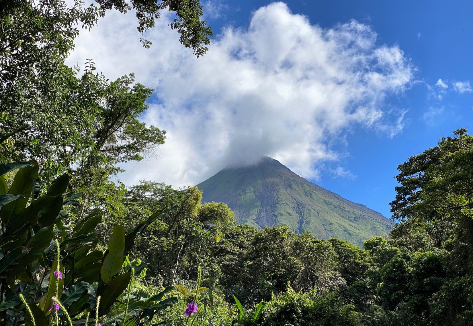 Costa Rica’s Arenal Volcano peaking through the rainforest