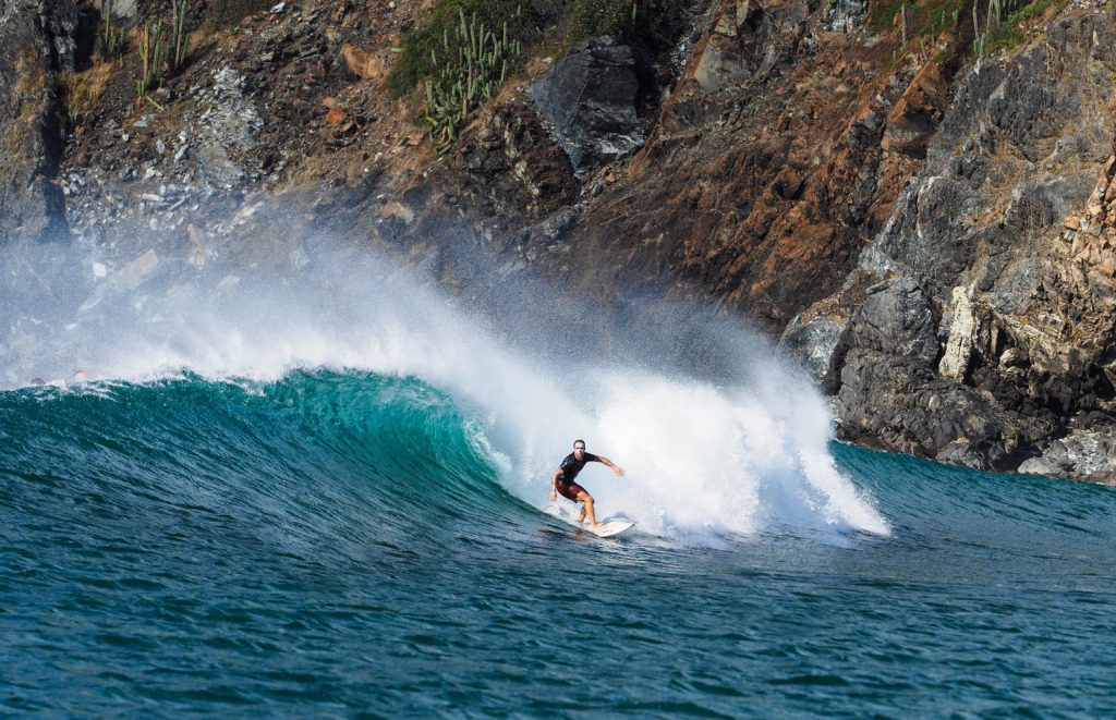 A surfer looks to make his next turn on a picturesque wave in one of Costa Rica’s best surfing spots