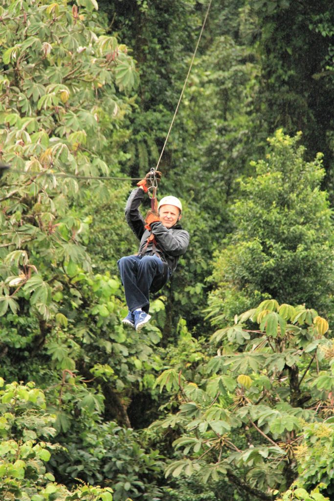 Man ziplining through Monteverde cloud forest in Costa Rica 