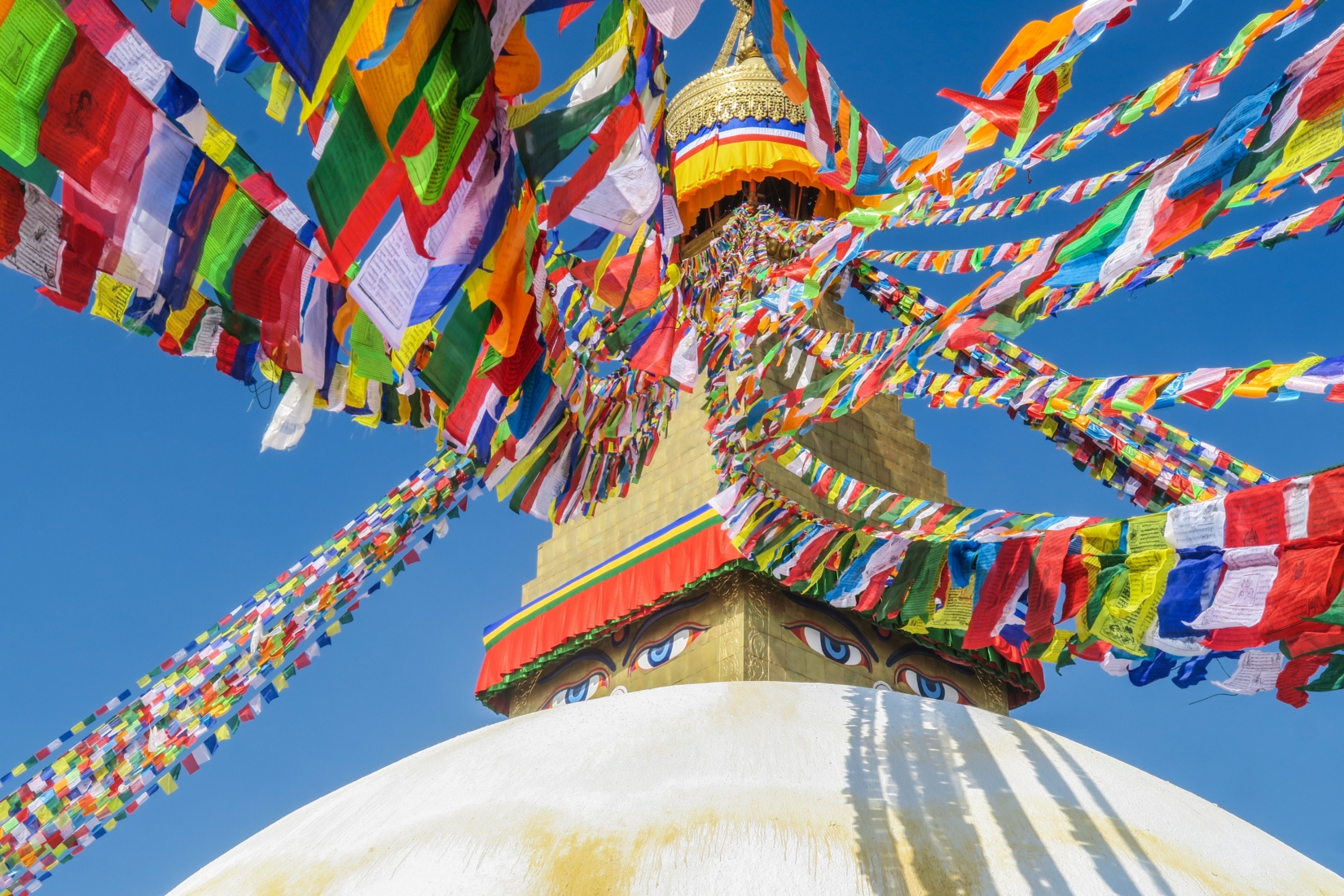 An image of colorful prayer flags adorning a sacred shrine in Durbar Square Kathmandu