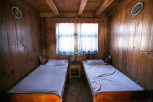 An interior photo of a guest bedroom in a mountain tea house on the trail to Everest Base Camp in the Himalayas