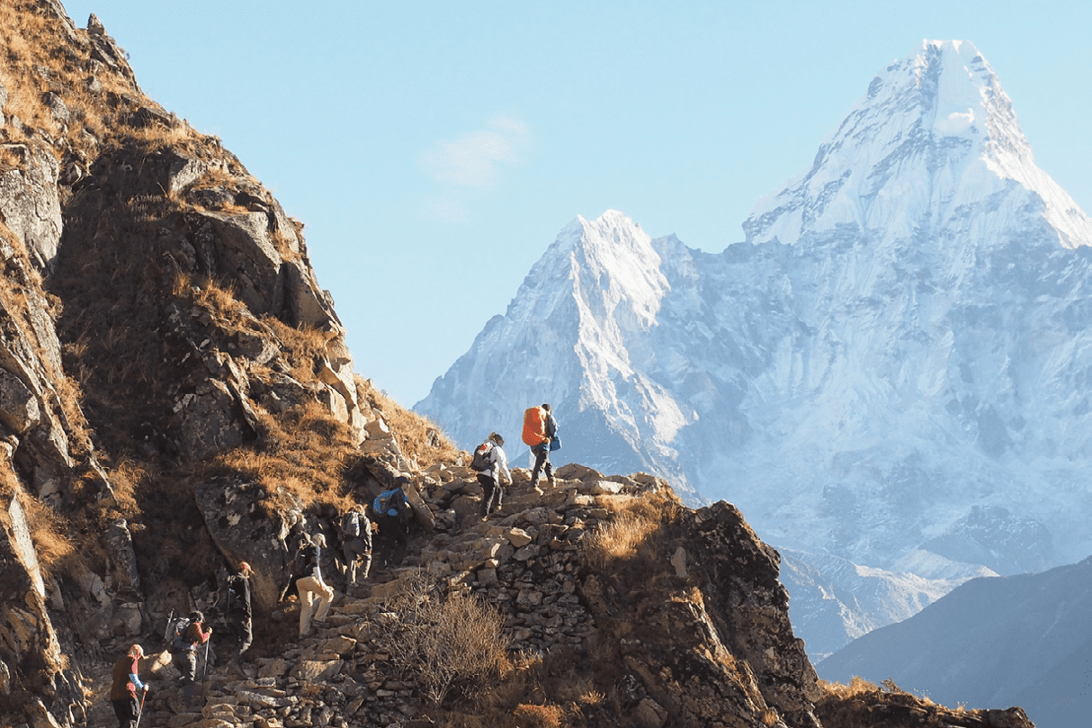 A photograph of a trekking group in front of Ama Dablam, on the trail to Everest Base Camp in Nepal's Khumbu Region