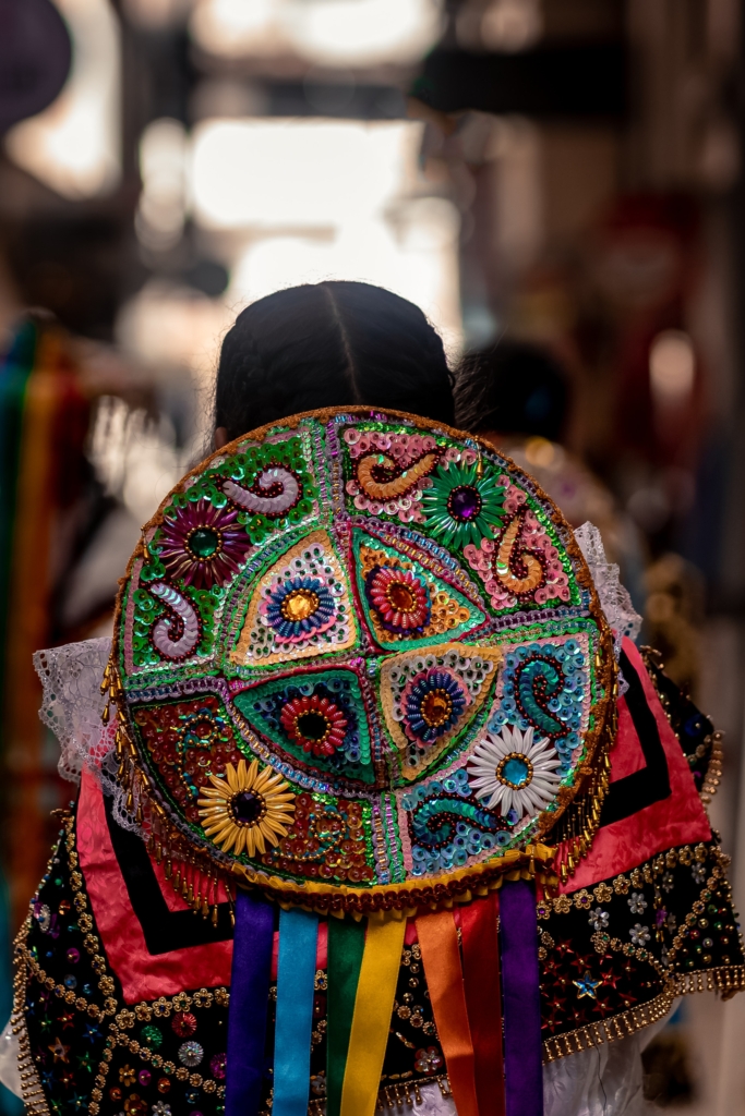 View of the back of a woman’s beaded peruvian costume for Virgen del Carmen festival