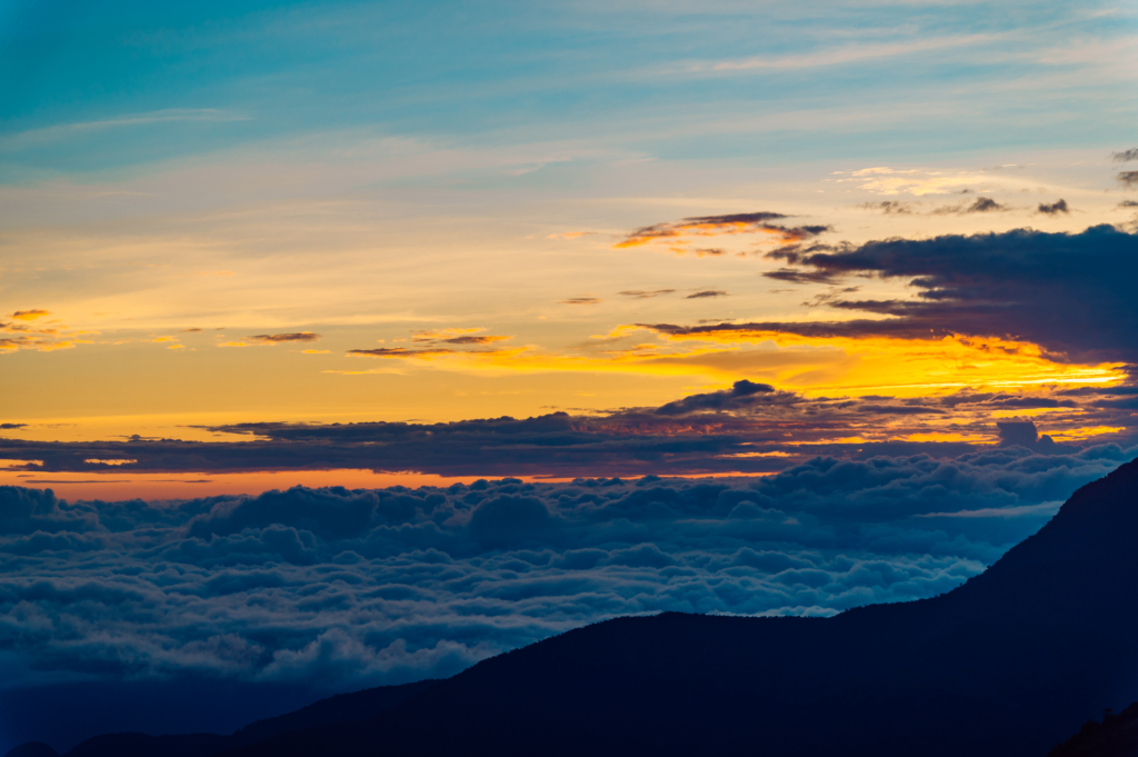 View of orange and yellow sunset from high mountain viewpoint in Manú National Park, Peru